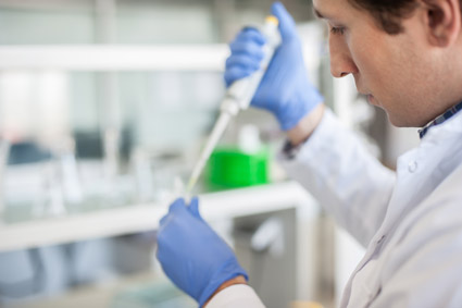 Scientist pipetting a tube using whole exome sequencing