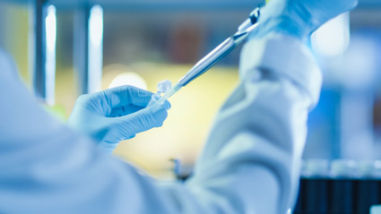 Scientist pipetting a tube